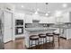 Kitchen with white cabinets, granite countertops, stainless steel appliances, and seating at the island at 127 Sanctuary Ave, Woodstock, GA 30188