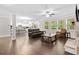 Open-concept living room that features hardwood floors, a fireplace, and a seamless transition into the kitchen at 127 Sanctuary Ave, Woodstock, GA 30188