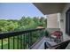 Relax on this charming balcony with comfortable seating and serene views of lush greenery at 1800 Clairmont Lk # 413, Decatur, GA 30033