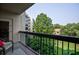 Relaxing condo balcony view with seating and view of mature trees and complex grounds at 1800 Clairmont Lk # 413, Decatur, GA 30033