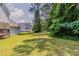 Spacious backyard featuring a green lawn and mature trees, perfect for outdoor activities at 3037 Botany Dr, Jonesboro, GA 30236