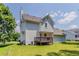 Side exterior view with wooden deck, surrounded by green lawns and trees at 3037 Botany Dr, Jonesboro, GA 30236