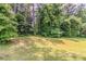 Lawn featuring mature trees, providing shade and a natural backdrop at 3037 Botany Dr, Jonesboro, GA 30236