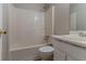 Bathroom featuring a shower and tub combination with white tiles, plus a vanity with sink at 3037 Botany Dr, Jonesboro, GA 30236