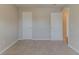 A bedroom contains two doors and a window with carpet floors at 3037 Botany Dr, Jonesboro, GA 30236