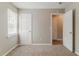 An open bedroom offers carpet floors, a window and two doors leading to other spaces at 3037 Botany Dr, Jonesboro, GA 30236