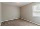 This bedroom offers a neutral space for personalization and has natural light coming in through the window at 3037 Botany Dr, Jonesboro, GA 30236