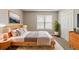 A bright bedroom features a wooden bed, a window, plants and decor at 3037 Botany Dr, Jonesboro, GA 30236