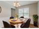Charming dining room with modern light fixture, table set for four, and plant at 3037 Botany Dr, Jonesboro, GA 30236