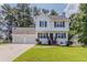 Charming two-story home with a well-maintained front yard and a two-car garage at 3037 Botany Dr, Jonesboro, GA 30236