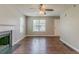 Spacious living room featuring hardwood floors, fireplace, and large windows at 3037 Botany Dr, Jonesboro, GA 30236
