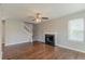 Bright living room with fireplace, hardwood floors, and staircase access at 3037 Botany Dr, Jonesboro, GA 30236