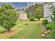 Lush backyard with stepping stones, mature trees, and a charming fire pit at 501 Grace Ct, Temple, GA 30179