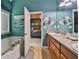 Bathroom featuring tiled floors, a soaking tub with succulent plants, and a door to the main bedroom at 501 Grace Ct, Temple, GA 30179