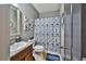 Bathroom features vanity with sink, a toilet, mirror and shower with curtain at 501 Grace Ct, Temple, GA 30179