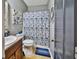 Bathroom features vanity with sink, a toilet, mirror and shower with curtain at 501 Grace Ct, Temple, GA 30179