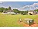 Spacious grassy front yard featuring residential homes and bright skies in the background at 501 Grace Ct, Temple, GA 30179