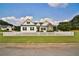 Charming home with a white picket fence, lush green lawn and a mix of stone and siding exterior at 501 Grace Ct, Temple, GA 30179