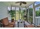 Relaxing screened porch with cozy seating and view of the landscaped backyard at 501 Grace Ct, Temple, GA 30179