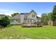 A spacious yard with a wooden deck and a gazebo, framed by trees and a fence at 1920 Lee Patrick Dr, Dacula, GA 30019