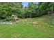 A lush backyard featuring a charming playhouse and terraced landscaping at 1920 Lee Patrick Dr, Dacula, GA 30019