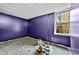 Unfinished basement with purple paint, a small window, and scattered painting supplies at 1920 Lee Patrick Dr, Dacula, GA 30019