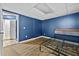 Basement with hardwood floors, a bed frame and blue accent walls at 1920 Lee Patrick Dr, Dacula, GA 30019
