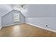Attic bedroom featuring light blue paint, an overhead fan, and hardwood floors at 1920 Lee Patrick Dr, Dacula, GA 30019