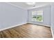 Light filled bedroom with hardwood floors and a window offering verdant views at 1920 Lee Patrick Dr, Dacula, GA 30019