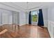 Light-filled dining room with hardwood floors, classic wainscoting, and stylish chandelier at 1920 Lee Patrick Dr, Dacula, GA 30019
