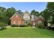 Charming two-story brick home featuring well-maintained landscaping and a welcoming front entrance at 1920 Lee Patrick Dr, Dacula, GA 30019
