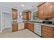 Bright kitchen with stainless steel dishwasher, ample cabinets, and backyard views at 1920 Lee Patrick Dr, Dacula, GA 30019