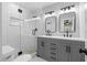 Bathroom showcasing tile shower, double sink vanity, and modern fixtures at 2209 Browns Mill Se Rd, Atlanta, GA 30315