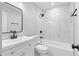 Modern bathroom featuring white marble tiling and sleek black fixtures, complemented by a stylish vanity and mirror at 2209 Browns Mill Se Rd, Atlanta, GA 30315