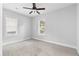 Bright bedroom with neutral carpet, two windows with blinds and a ceiling fan at 2209 Browns Mill Se Rd, Atlanta, GA 30315