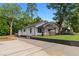 Charming renovated home with a fresh white exterior, landscaped yard, and long driveway at 2209 Browns Mill Se Rd, Atlanta, GA 30315