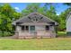 Charming home with a welcoming front porch, complemented by a beautifully maintained lawn and fresh landscaping at 2209 Browns Mill Se Rd, Atlanta, GA 30315