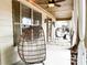 Cozy back porch with hanging chairs, string lights, and great natural light at 2439 Muirfield Pl, Atlanta, GA 30337