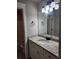 Bathroom with a vanity featuring granite countertops and a large mirror at 2439 Muirfield Pl, Atlanta, GA 30337