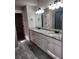 Bathroom with granite counters, double vanity and modern lighting at 2439 Muirfield Pl, Atlanta, GA 30337
