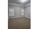 Bright bedroom with two windows featuring blinds and neutral carpet at 2439 Muirfield Pl, Atlanta, GA 30337
