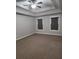 Large bedroom with trey ceiling, ceiling fan and two windows at 2439 Muirfield Pl, Atlanta, GA 30337