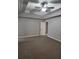 Bedroom features trey ceiling with ceiling fan and connecting door to en-suite bathroom at 2439 Muirfield Pl, Atlanta, GA 30337