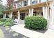 Inviting covered front porch with decorative curtains and lush landscaping at 2439 Muirfield Pl, Atlanta, GA 30337
