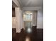Elegant hallway with dark hardwood floors and decorative columns, leading to the open-concept living space at 2439 Muirfield Pl, Atlanta, GA 30337