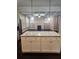 Kitchen island featuring granite countertops and pendant lighting with the living area and fireplace in the background at 2439 Muirfield Pl, Atlanta, GA 30337