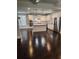 Modern kitchen with stainless steel appliances, white cabinets, island, and hardwood floors in an open layout at 2439 Muirfield Pl, Atlanta, GA 30337