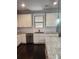 Kitchen featuring white cabinets, stainless steel appliances, and granite countertops with a view from the island at 2439 Muirfield Pl, Atlanta, GA 30337