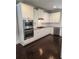 Spacious kitchen with white cabinets, stainless steel appliances, granite countertops, and hardwood flooring at 2439 Muirfield Pl, Atlanta, GA 30337