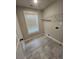 Laundry room with tile flooring, overhead rack, and window at 2439 Muirfield Pl, Atlanta, GA 30337
